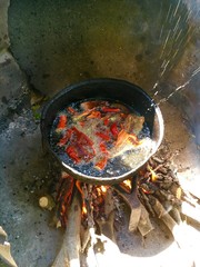 Peppers are frying in hot oil at village