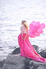 beautiful girl on the beach with balloons