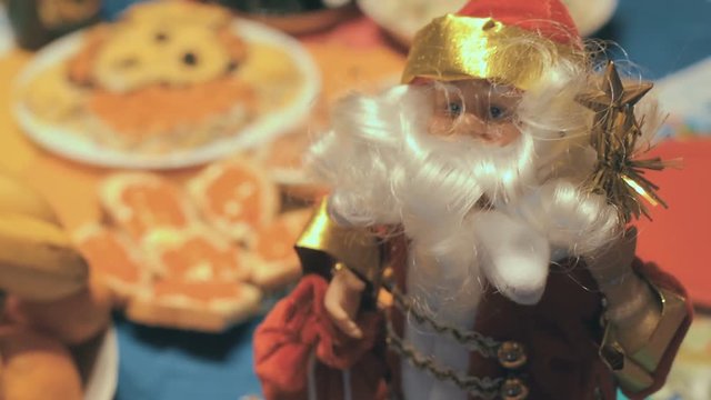 Toy Santa Under The Holiday Table