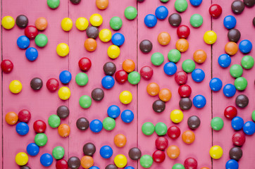 Fototapeta na wymiar candies on a wooden pink table