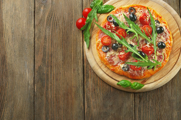 Tasty pizza with vegetables, herbs on wooden background