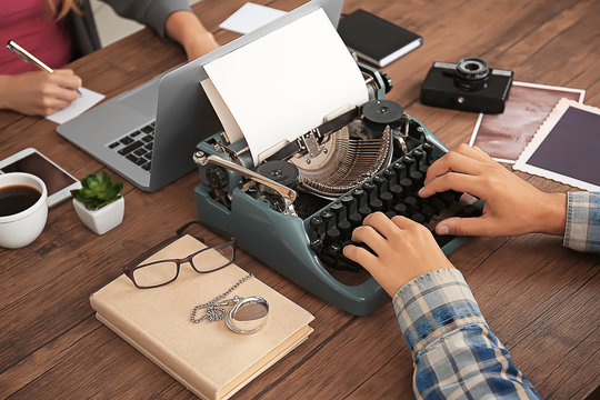 Old typewriter and laptop, concept of technology progress