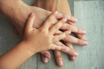 Family hands on wooden background