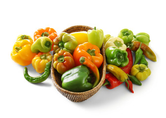 Basket with fresh peppers on white background