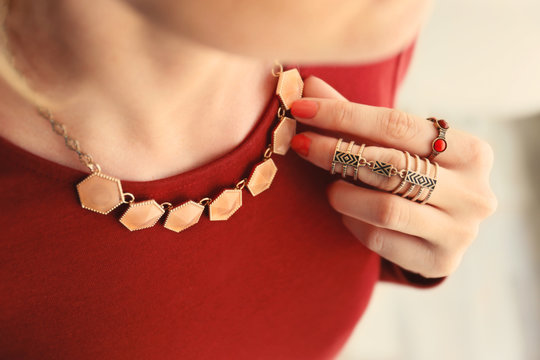Female Hand With Beautiful Accessories Holding Necklace, Close Up