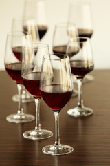 Glasses with red wine in a row on a table