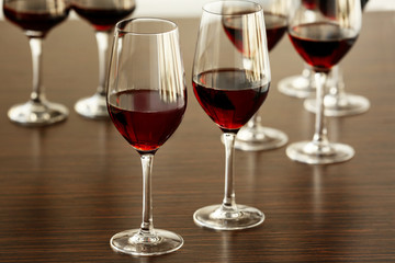Glasses with red wine in a row on a table