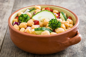 Chickpea salad isolated on wooden background

