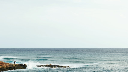 Bride and groom near the ocean