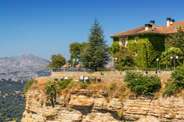 Fototapeta premium Buildings on the cliffside of El Tajo Gorge in Ronda, Malaga province, Spain.