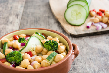 Chickpea salad isolated on wooden background

