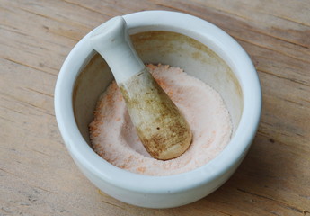 crushed pill cup on wooden board