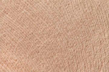 Light brown background from soft textile material. Fabric with natural texture.