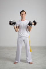 Young Man doing Exercise with Dumbbells.