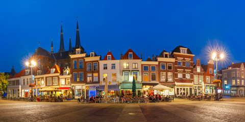 Panorama wiyh typical Dutch houses on the Markt square in the center of the old city at night, and Maria van Jessekerk on the background, Delft, Holland, Netherlands
