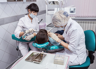 Dental clinic, dental treatment at the brunette.