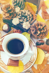 Obraz na płótnie Canvas Autumn Cup of black coffee, chestnuts, pine cones, chocolate and autumn leaves. Autumn background. Autumn scene. Coffee and autumn leaves. Fall background. Autumn colors.