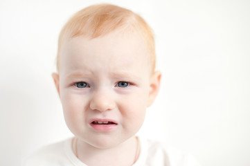 Redhead baby crying close-up