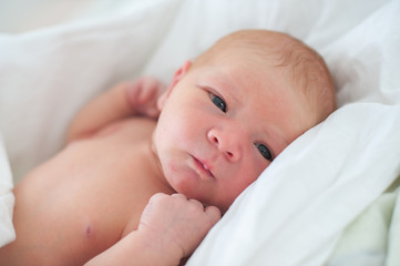 Newborn baby lying in a crib