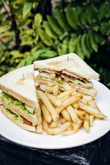 club sandwich snack with french fries on plate