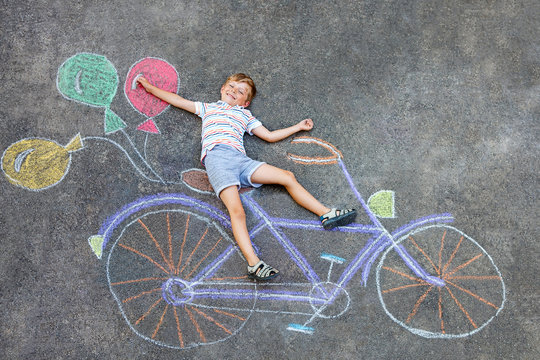 little kid boy having fun with bike chalks picture 
