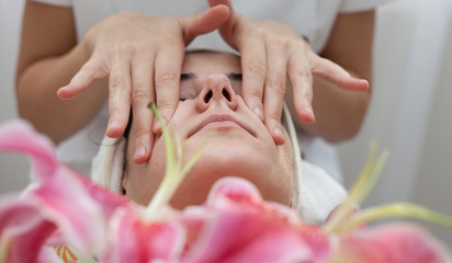 Facial massage,beautician makes facial massage ,skin treatment to a beautiful young girl