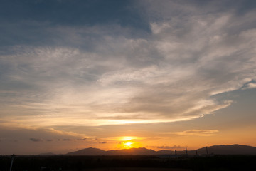 Fototapeta na wymiar Dramatic sunset sky with orange and blue colored clouds.