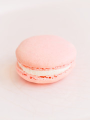 Rose macaron on a pinkish background.