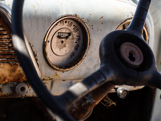 Speedometer and dashboard of an old wreck car left on a Namib de