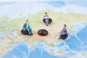 Miniature people sit on world map. business international communicate concept