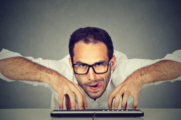 Crazy looking nerdy man typing on the keyboard