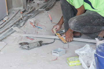 Carpenter sawing wood board,carpenter chips from a circular saw at construction site