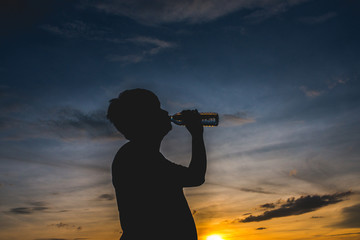 Silhouette with man's drinking water