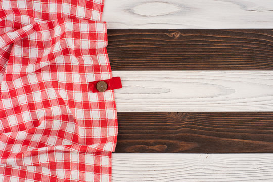red folded tablecloth over wooden table.