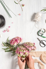 The florist desktop with working tools and ribbons