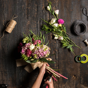 The florist desktop with working tools and ribbons