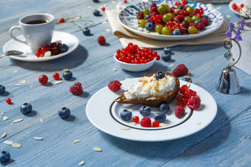 Breakfast with baked pea and berries at blue rustic wood