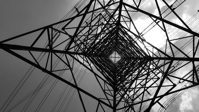 Bottom view of electric pole with beautiful sky in black and white shot. Plant, Power.