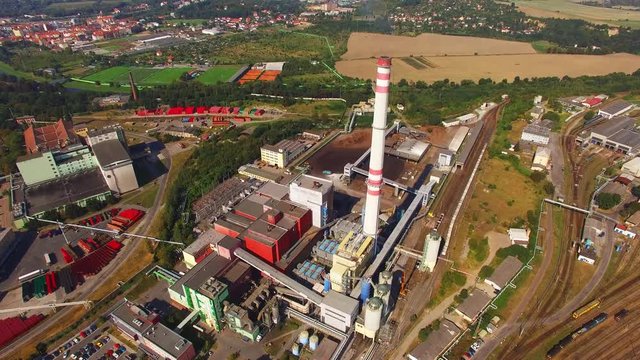 Aerial view of modern combined heat and power plant. Fuming chimney with sulphur removal unit. Heavy industry from above. Power and fuel generation in Czech Republic, European Union.