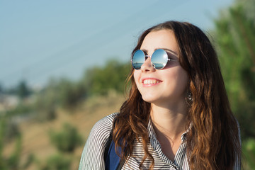 Portrait of a beautiful happy woman on the nature