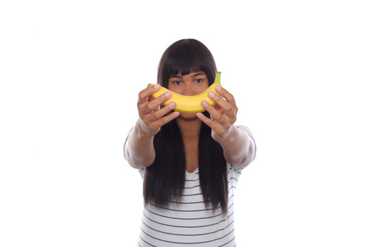 Afro Young Girl Holding Banana Towards Camera