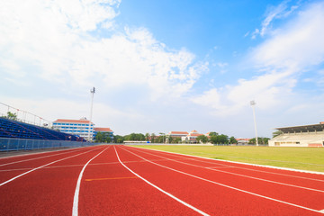 Running track ,Green lawn and blue sky.