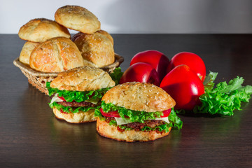 Close-up of home made tasty burgers on wooden table