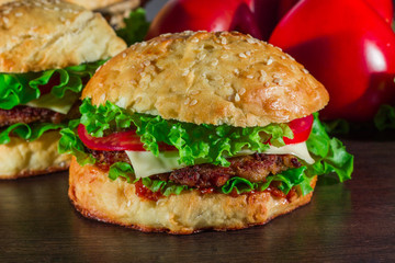 Close-up of home made tasty burgers on wooden table
