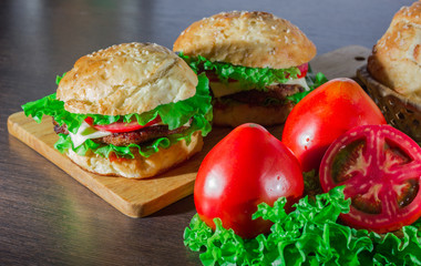 Close-up of home made tasty burgers on wooden table