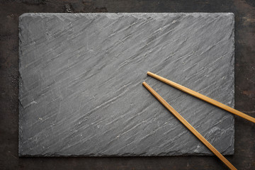 Sushi black slate and chopsticks