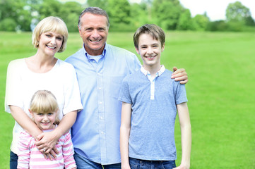 Fototapeta premium Smiling parents with their kids, outdoors