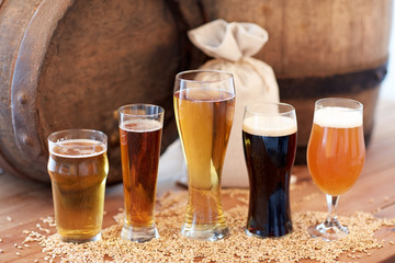 close up of beer barrel, glasses and bag with malt