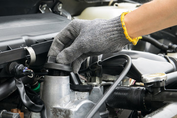 Fototapeta premium A mechanic is opening the oil cap from a car engine.