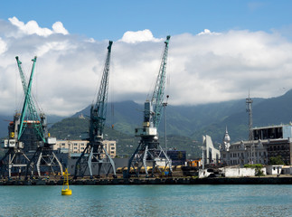 Fototapeta premium Cargo and transportation industry - cargo shipping and commercial terminal in seaport Batumi, Georgia. Industrial landscape with gantry cranes in a sea port.